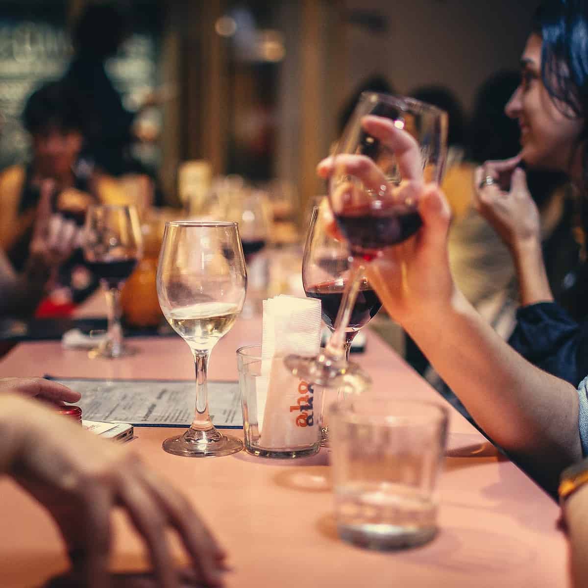pexels-photo-696218 people drinking liquor and talking on dining table close up photo
