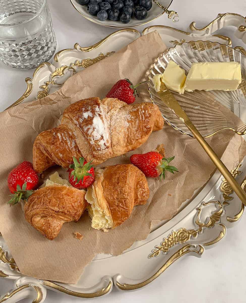 pexels-photo-8105130 croissants with strawberries and butter on white vintage dish