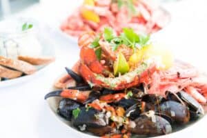 White bowl filled with mussels and a mix of seafood
