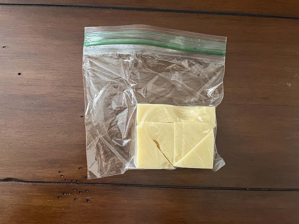 Block or swiss or emmentaler cheese precut and placed in a plastic bag with all air sqeezed out to maintain freshness