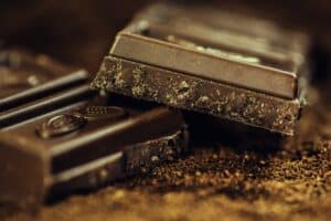 Chocolate bar snapped in half with halves stacked on top of one another