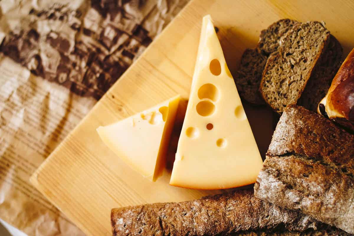 swiss cheese on a board-1 swiss cheese wedge on a cutting board