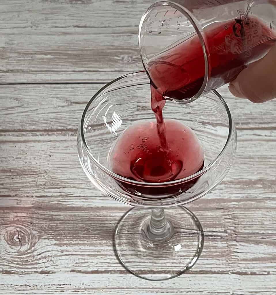 Adding Pomegranate mix to the Coupe Glass