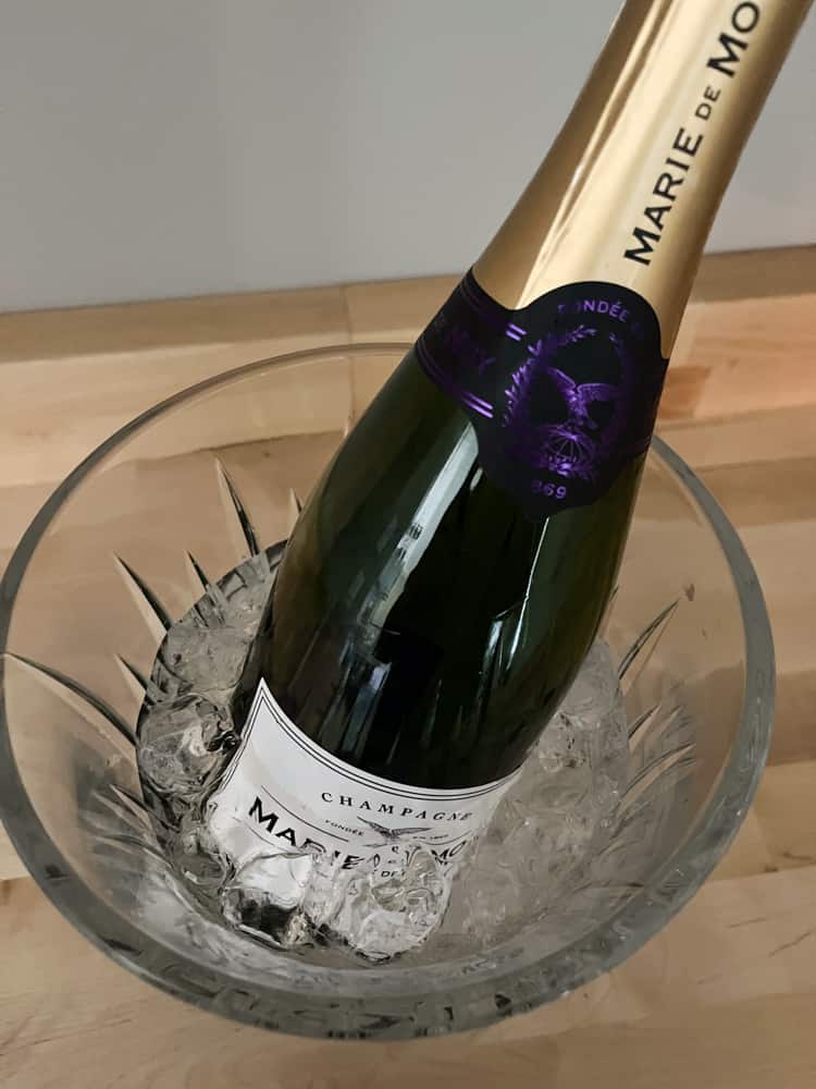 Champagne Bottle in Crystal Ice Bucket filled with ice and water.