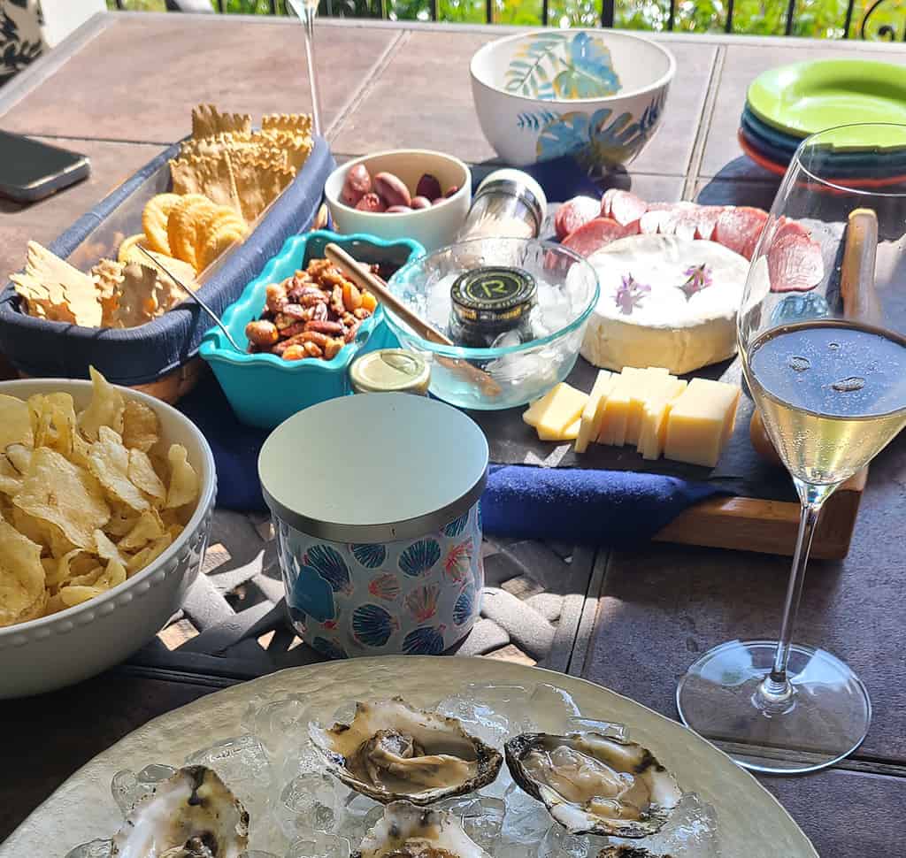 From Left: Crackers, Nuts, Caviar, Brie (Top), Comte (Below) , Forefront: Potato Chips and Oysters.