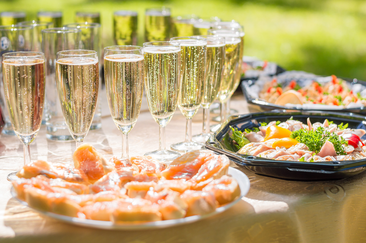 Wedding party buffet with champagne, canape, sandwiches Glasses of sparkling wine lined up and on the table with salmon and brunch items