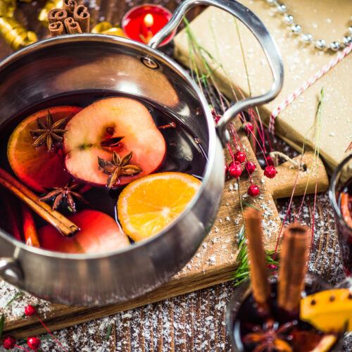 Serving mulled hot warming wine on festive Christmas table