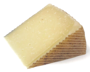 Wedge of Machego cheese - creamy straw color with variegated dark gray striped rind