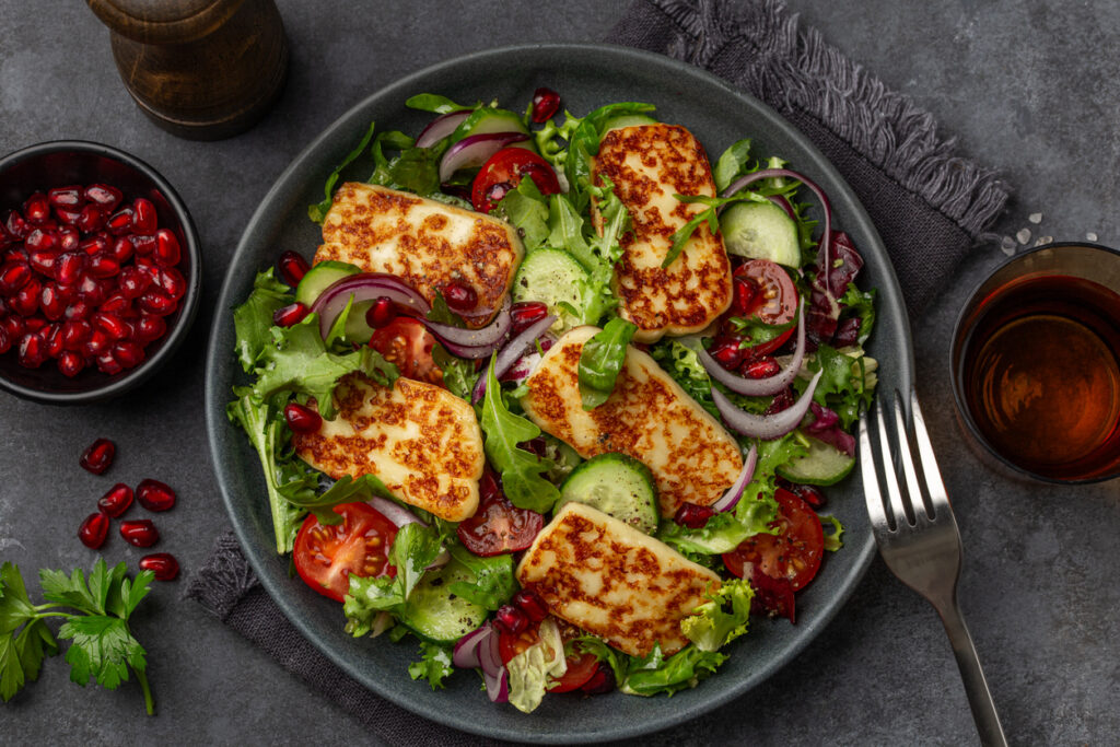 Grilled Halloumi salad with tomatoes, red onion and pomegranates.