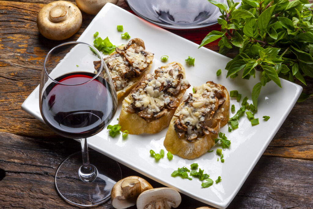 Mushroom bruschetta and grated parmesan and red wine