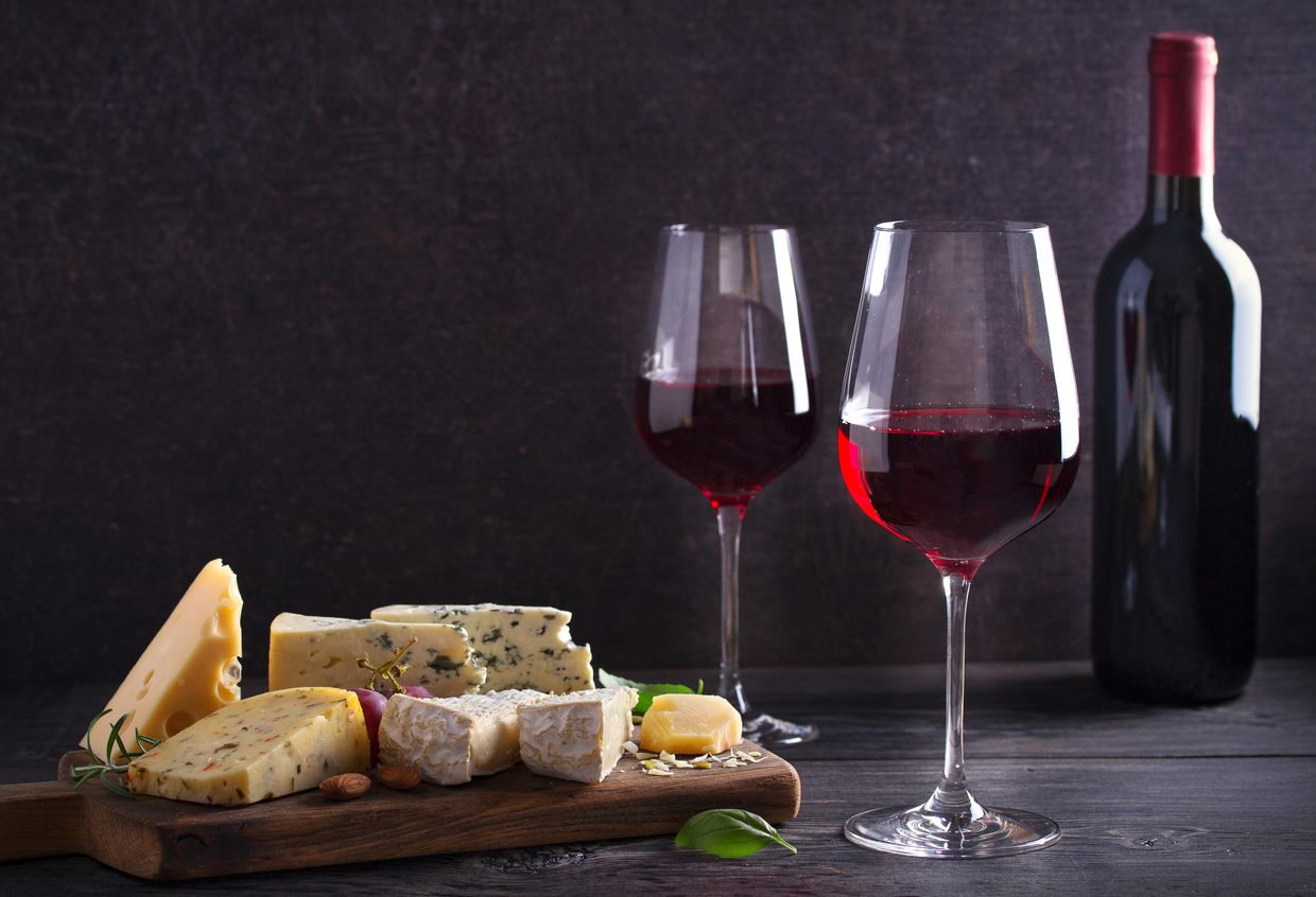 Red wine with cheese on chopping board. Wine and food concept Red wine with cheese on chopping board.