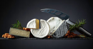 Various soft cheeses with walnuts and rosemary.