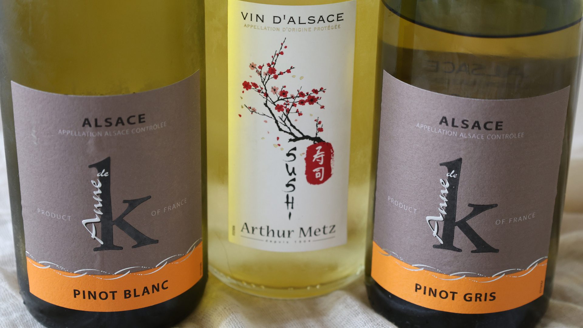 Pinot Blanc Bottle w_ Others 1920×1080 Three bottles lined up - a Pinot Blanc, a blend, and a Pinot Gris